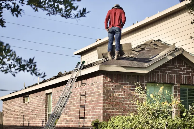 Professional roofer working on a residential roof in South Pointe